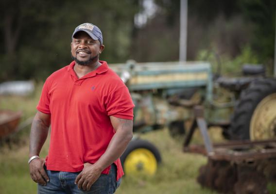 Jon Jackson standing on his farm