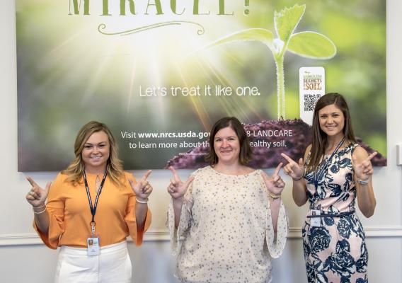 Victoria Chapman (left) and Vanessa Wiebe (right) show their school spirit with Sarah Haymaker, Oklahoma State University alum and fellow farmers.gov team member.