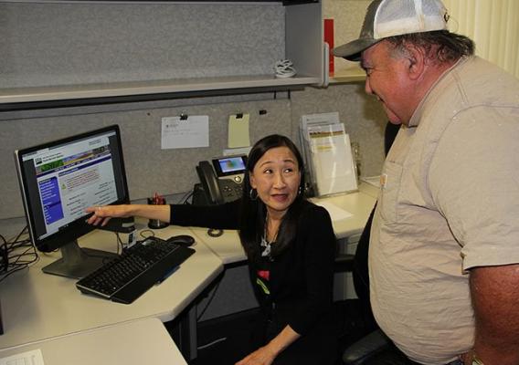 Farmer working with USDA employee.