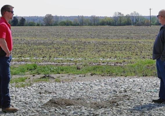 From left to right: NRCS District Conservationist Adam Eades and Farmer Joey Massey in Greene County Arkansas chat in a field