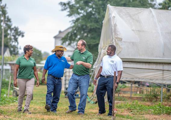 Chris discusses USDA programs for veterans with Georgia farmer Bobby Wilson while walking on Wilson&#039;s farm.