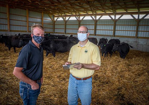 Ethan Whiteside (left) working with USDA on his operation. 