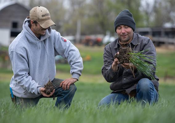 NRCS Soil Health Specialist Kent Vlieger (right) discusses soil structure with South Dakota Farmer Ryan Larson.