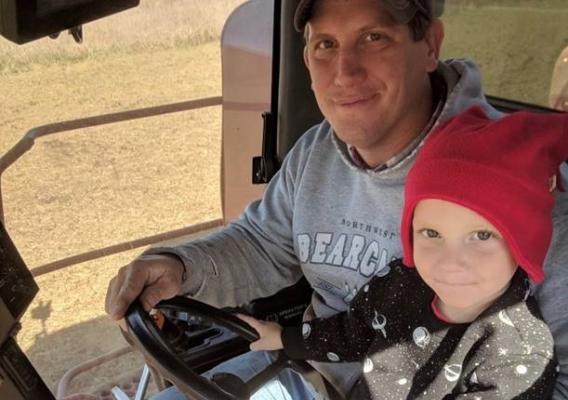 Brett Gilland and son in tractor cabin