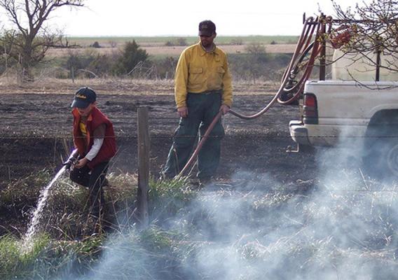People monitoring planned land burn
