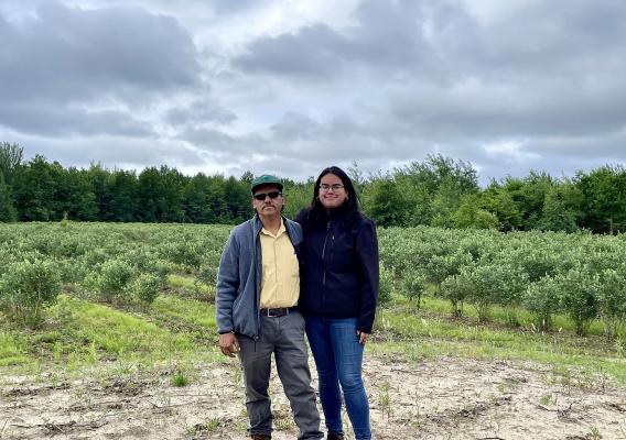 Two people standing in field