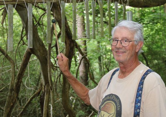 Person playing with wind chimes