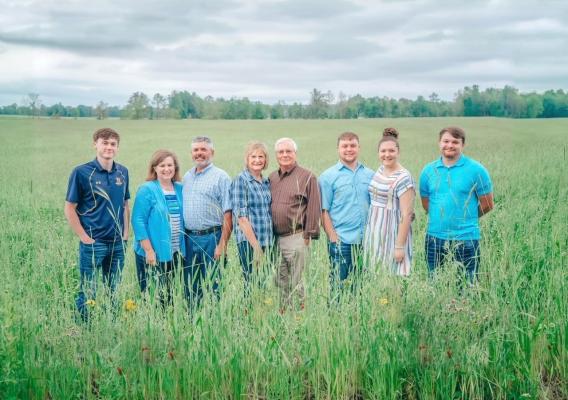 Eight people standing in a field