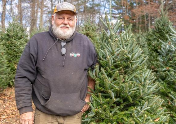 Person standing in front of trees