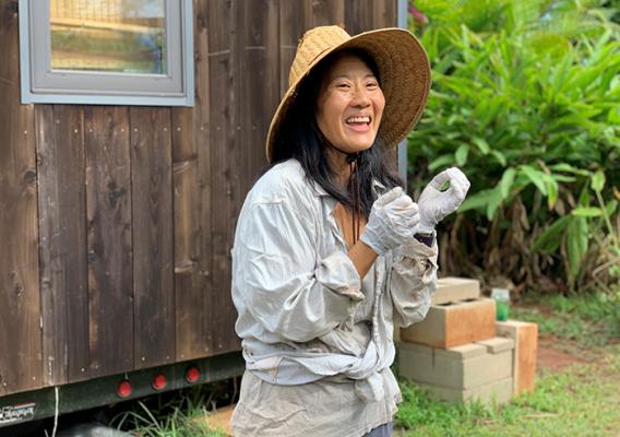 Person wearing straw hat in a garden