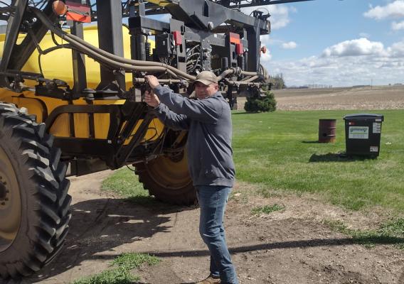 Person standing next to a tractor