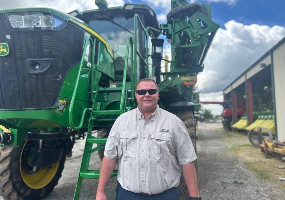 Person standing in front of a tractor