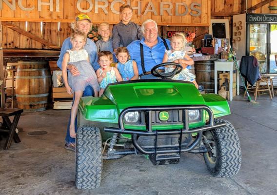 Six people sitting on a four wheeler