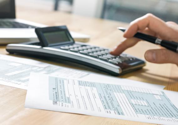 hands typing on calculator