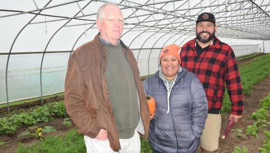 Bill Borgeld, NRCS, with Joe VanAlstine and Rosebud Schneider in a high tunnel with crops.