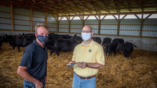 Ethan Whiteside (left) working with USDA on his operation. 