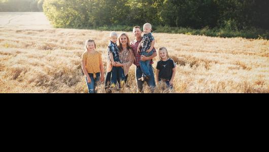 Six people standing in field