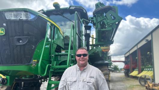 Person standing in front of a tractor