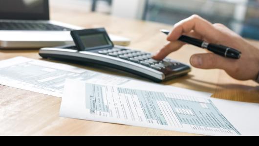 hands typing on calculator
