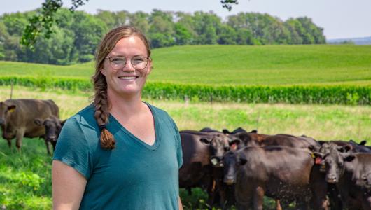 Person standing near grazing cattle