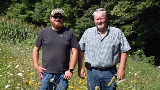 two people walking through flowers