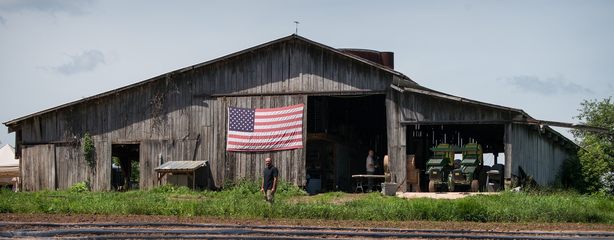 veteran in front of a barn